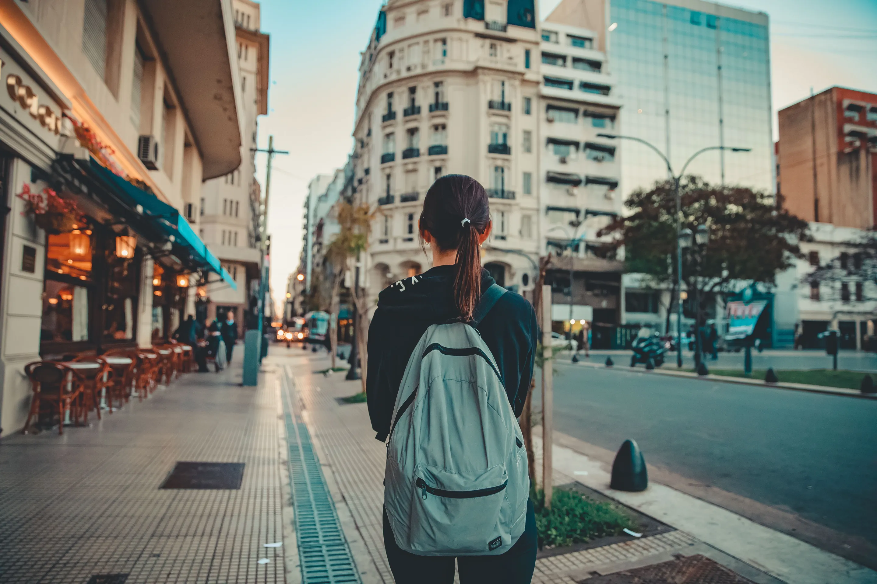 A traveller with a backpack on a colourful Buenos Aires street.