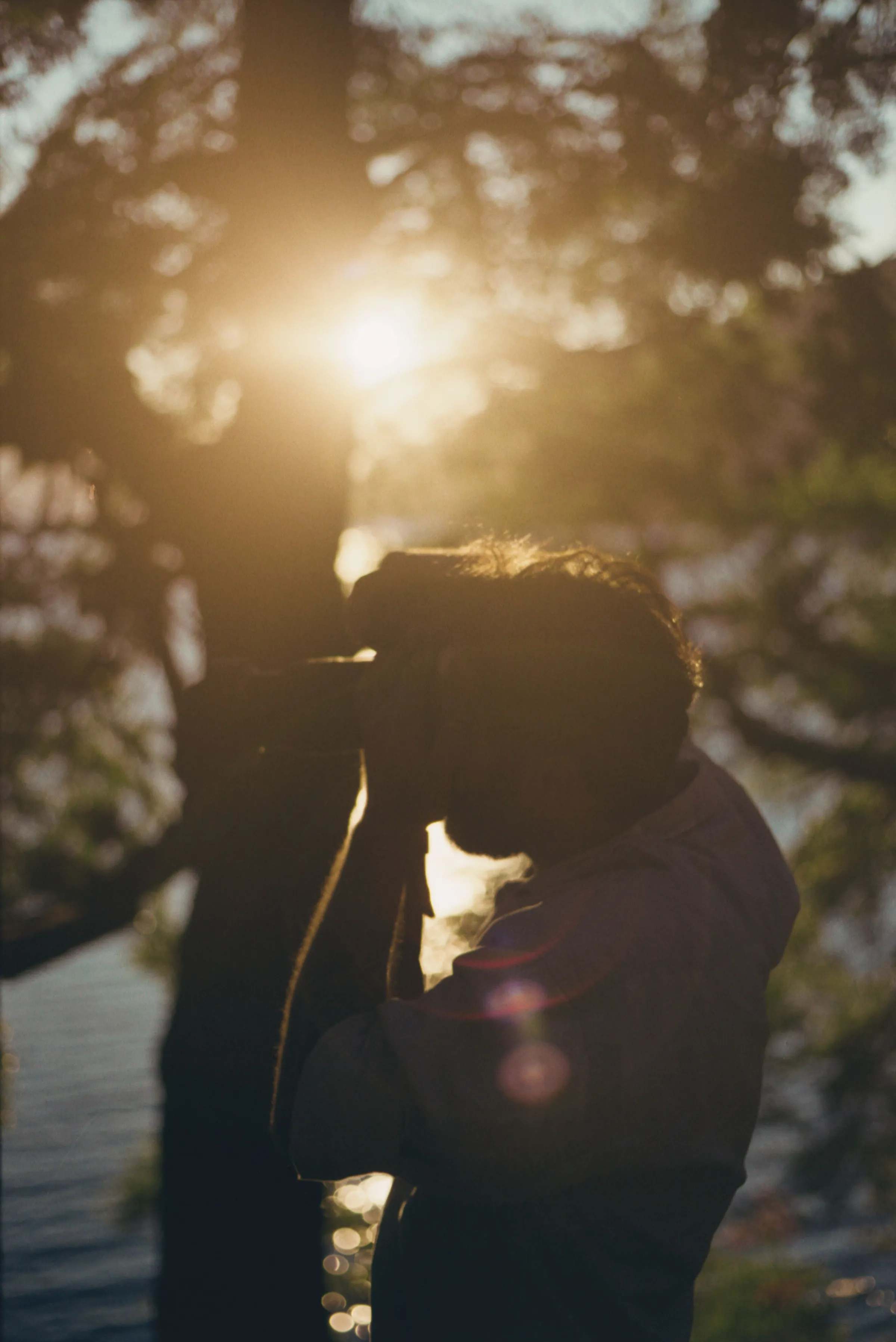 A photographer beside a lake in San Martín de los Andes at sunset.