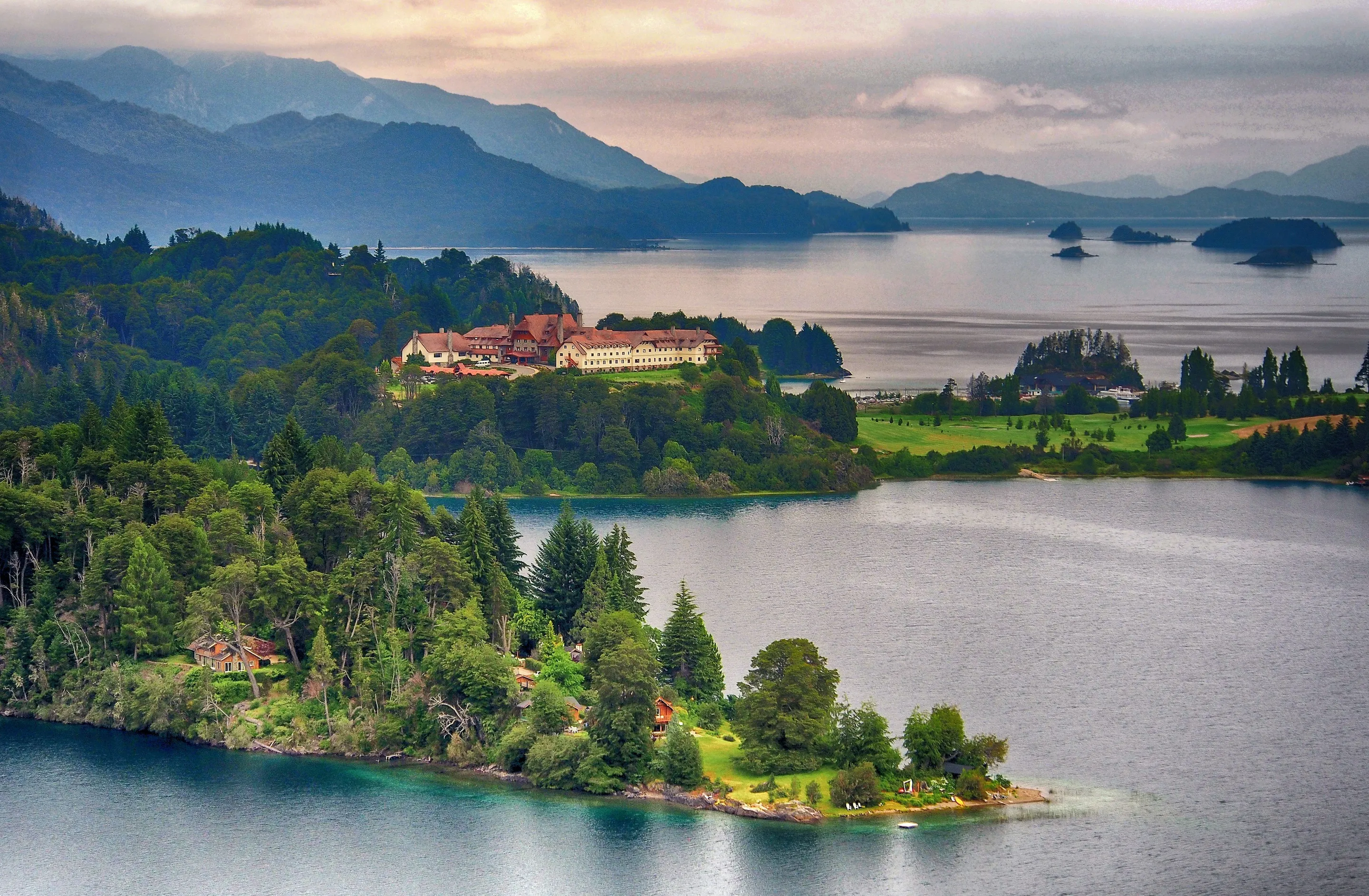 Warm sunset over the lake and forested peninsulas around Bariloche