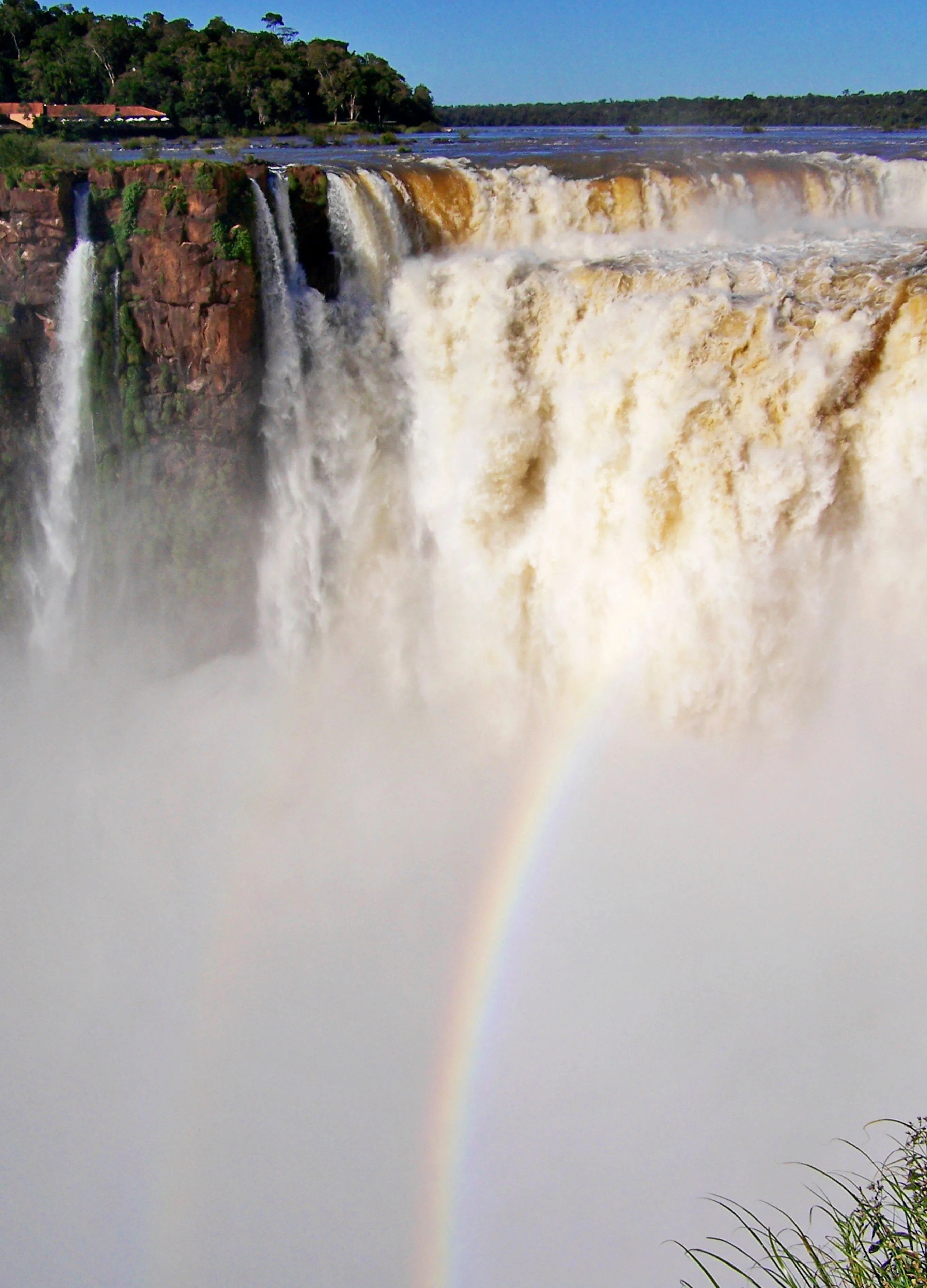 Iguazú Falls and rainbow seen through a curtain of spray