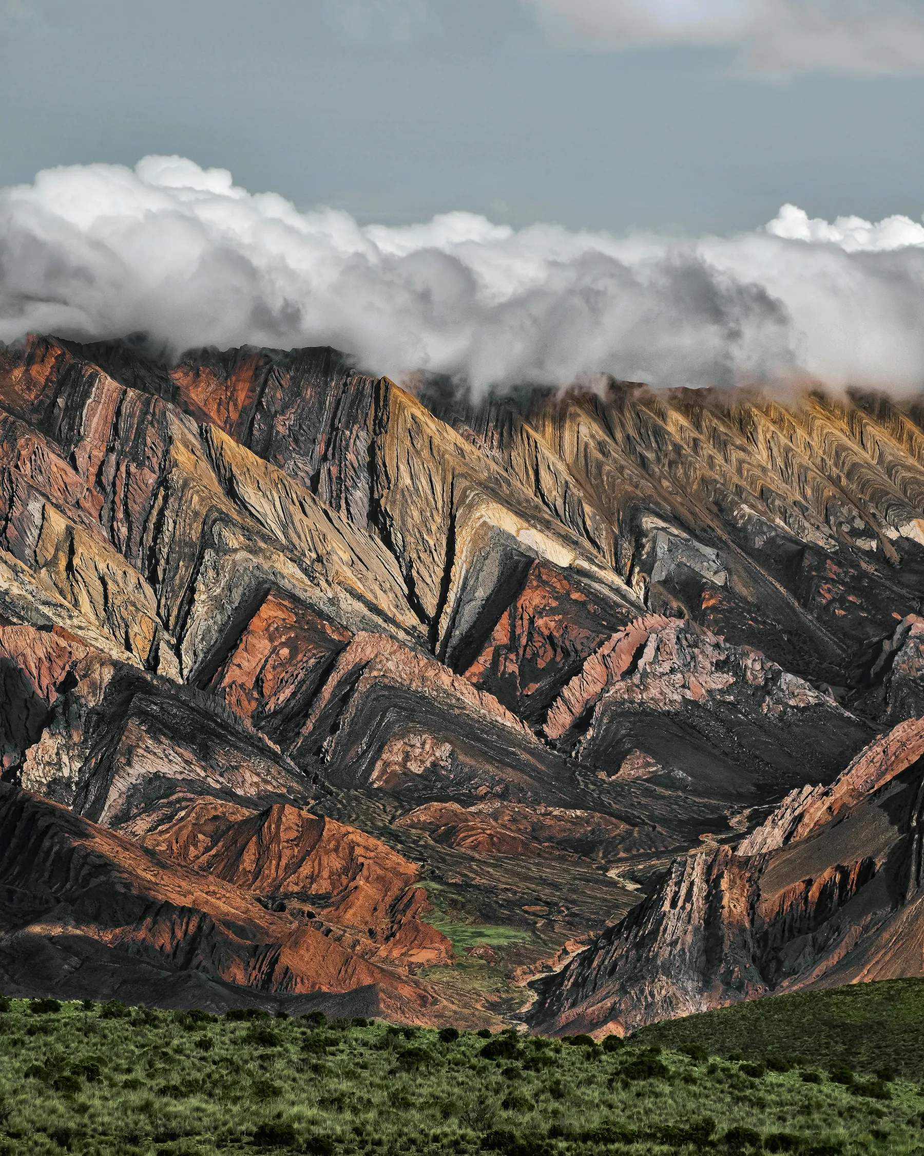 Colourful folded ridges of Hornocal beneath low clouds