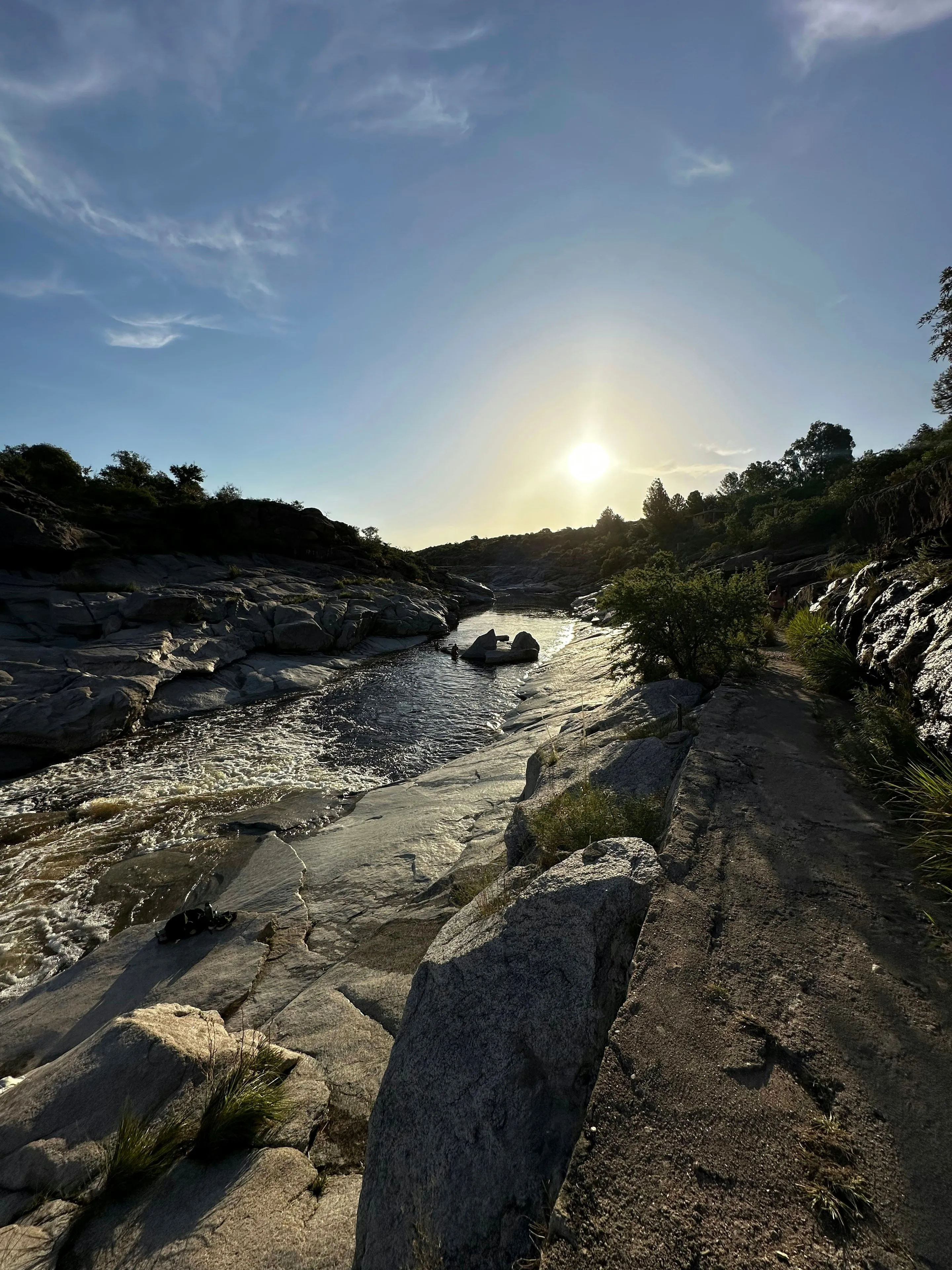 Evening light over the rocky river at La Toma in Mina Clavero