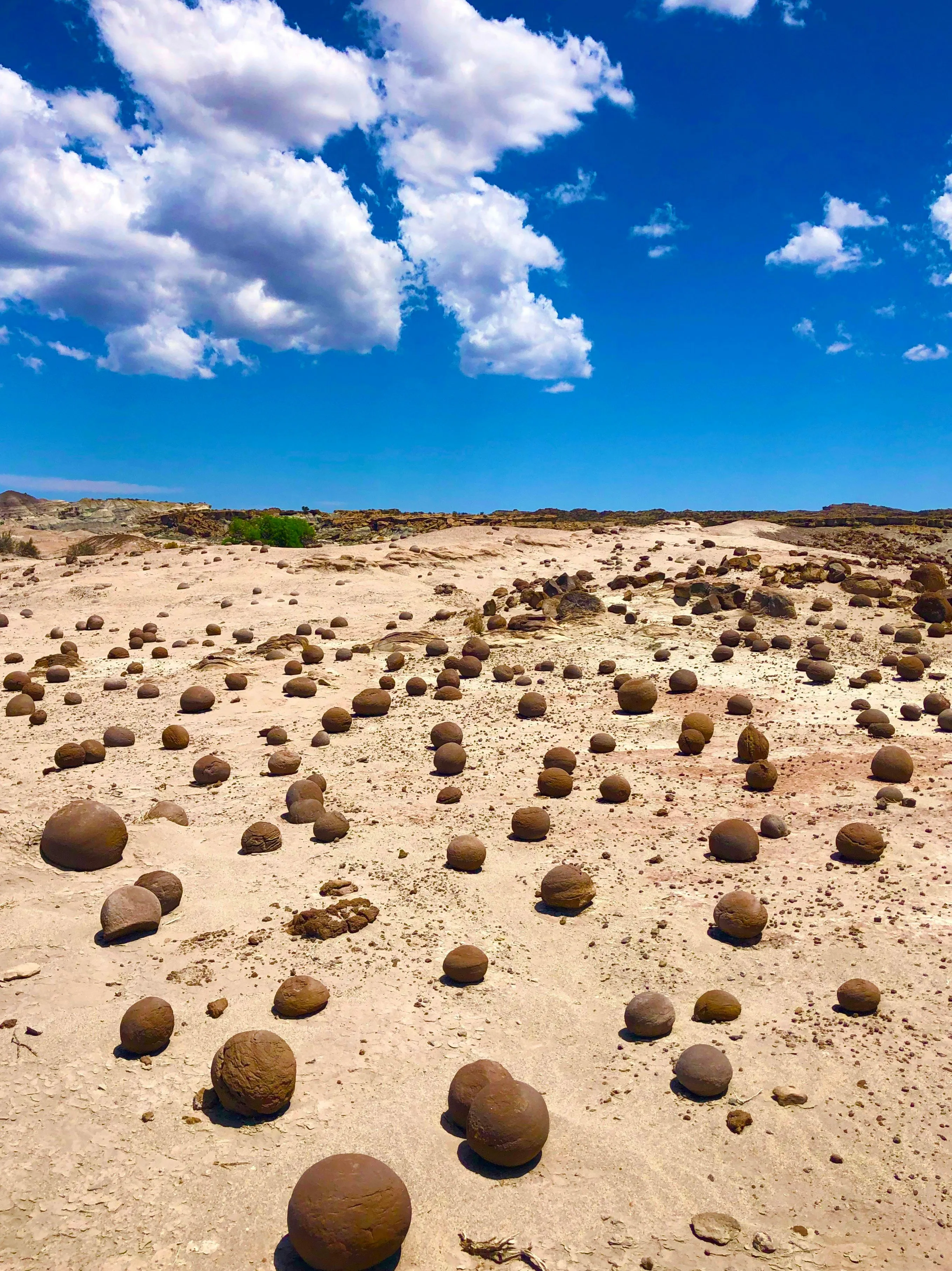 Spherical concretions beneath dramatic clouds at Cancha de Bochas in Ischigualasto