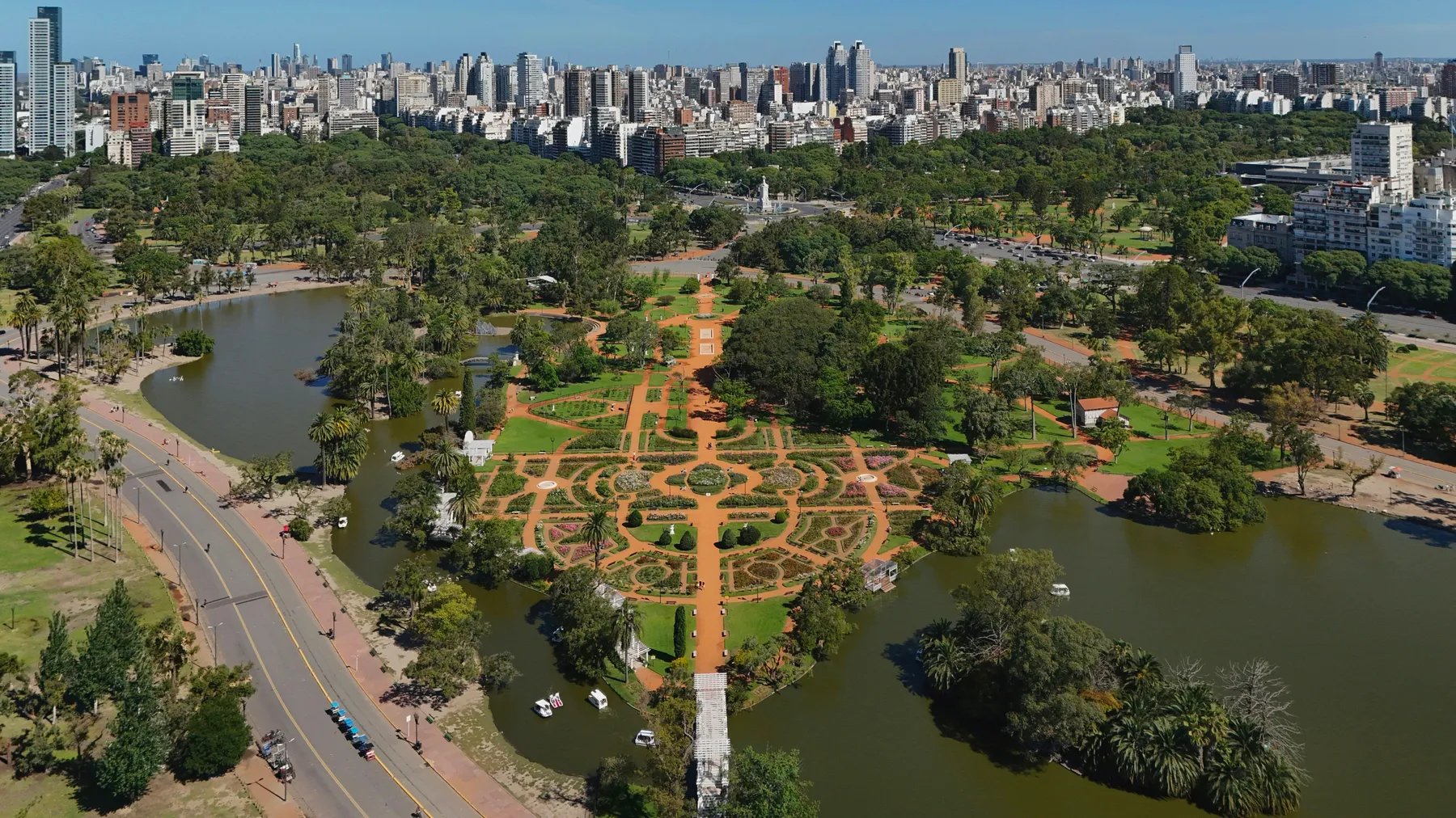 Aerial view of geometric garden paths, lakes and the city skyline at El Rosedal