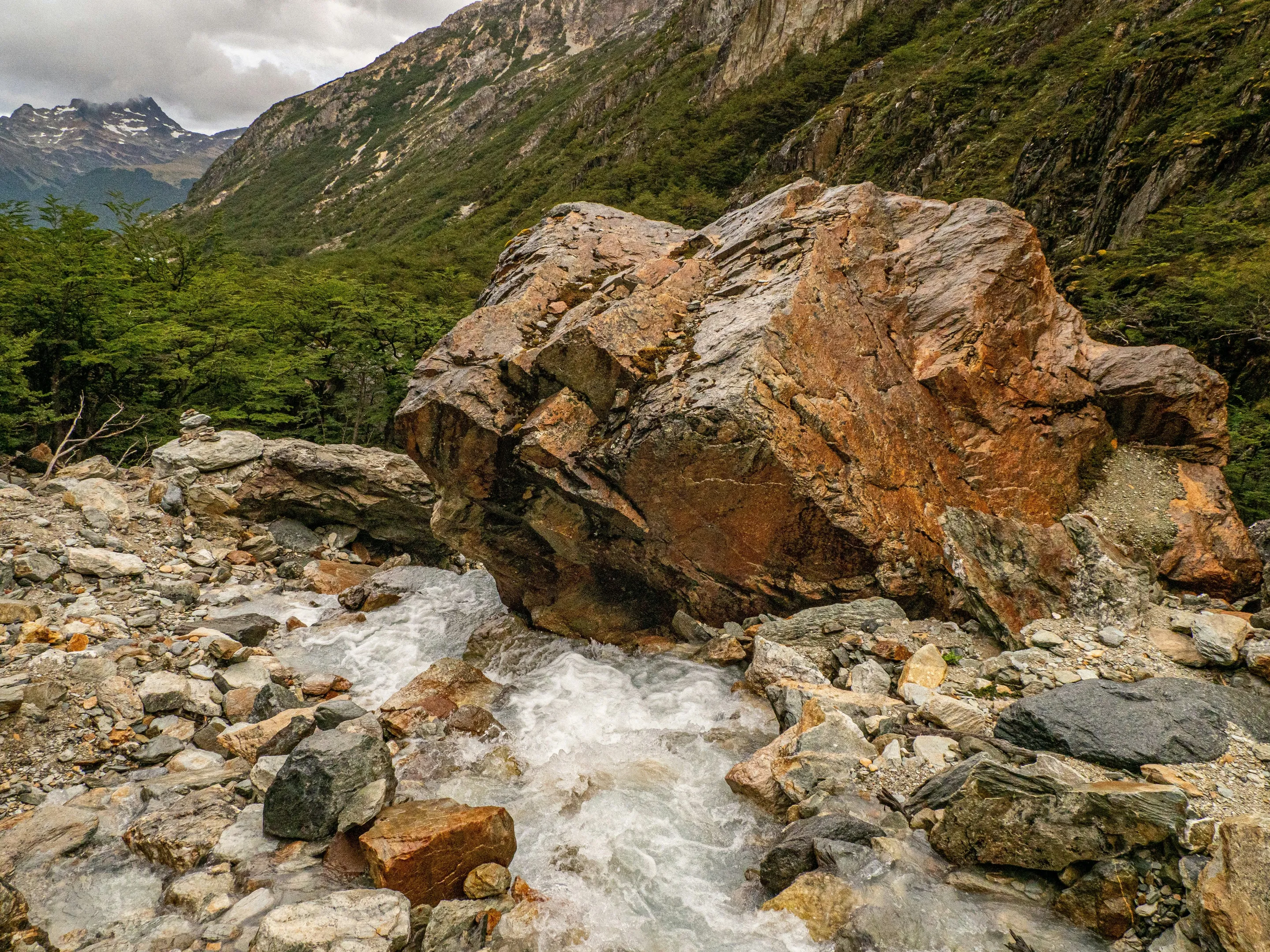 Rock, flowing water and mountains in Tierra del Fuego National Park.