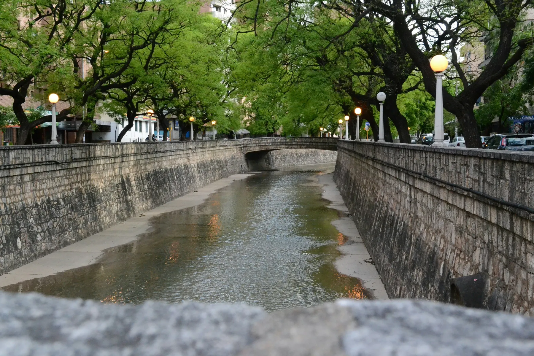 Trees and stone bridges along La Cañada in Córdoba