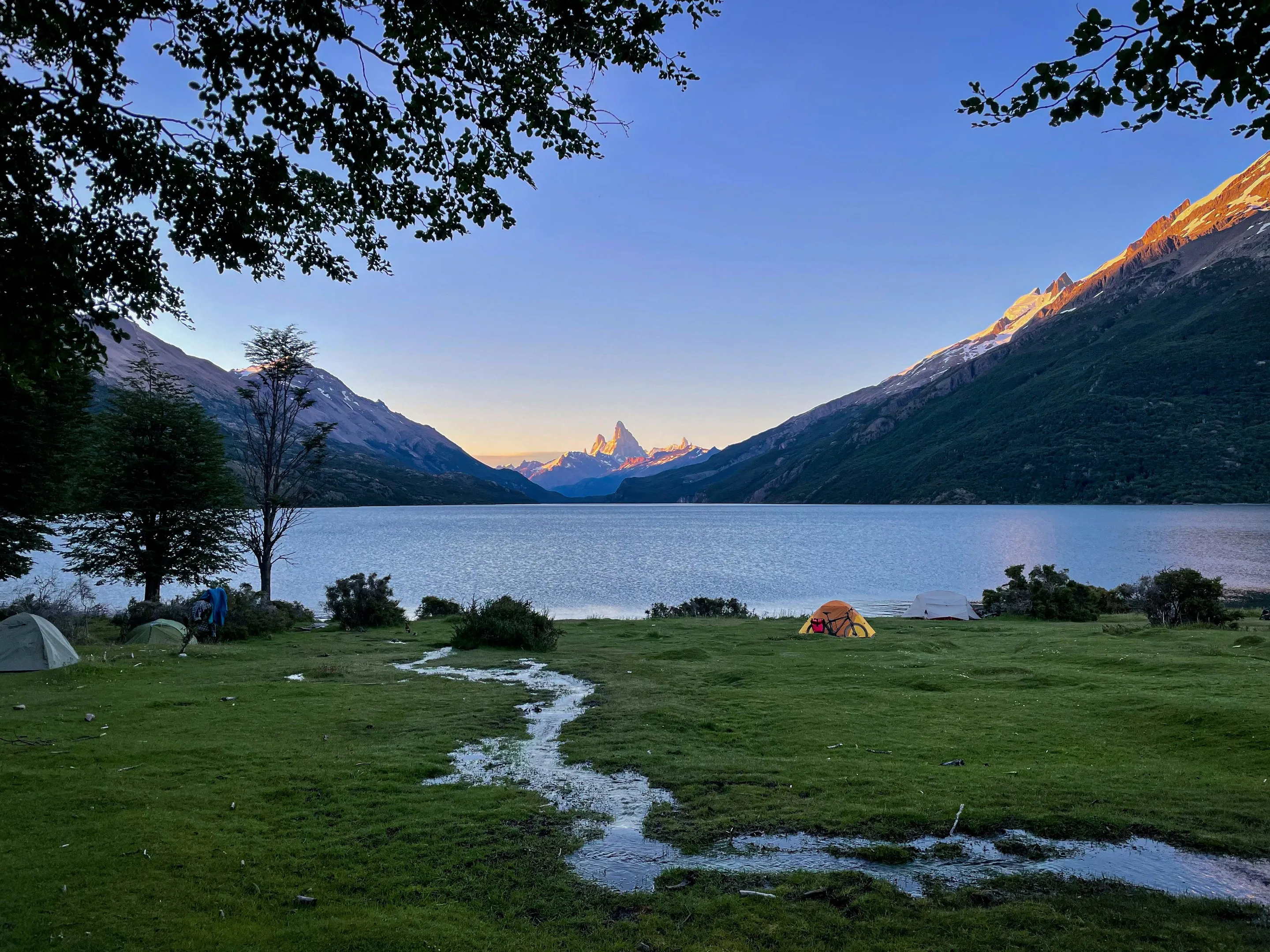 A tent on grass above Lago del Desierto in evening light
