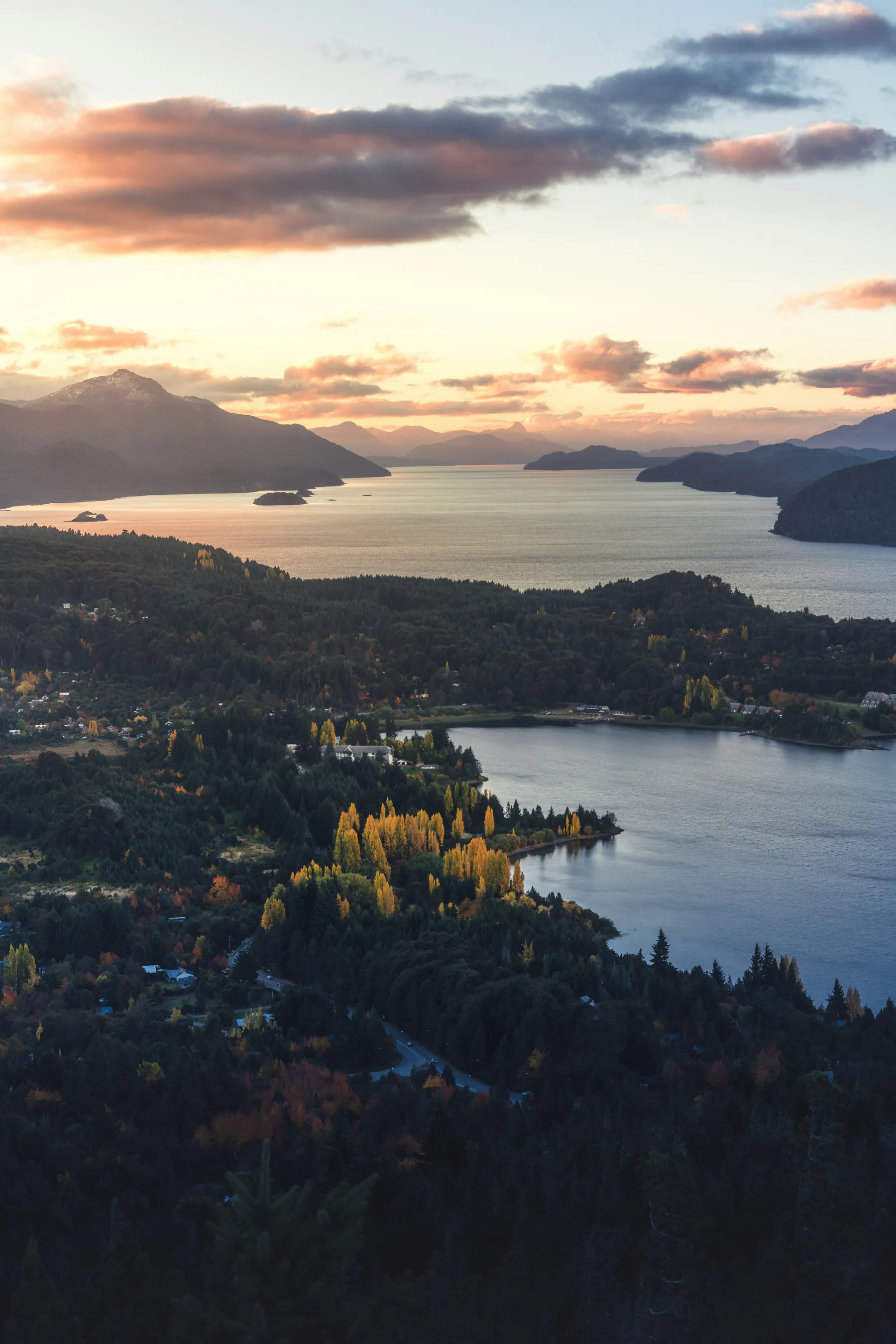 Warm evening light across lakes and mountains viewed from Cerro Campanario
