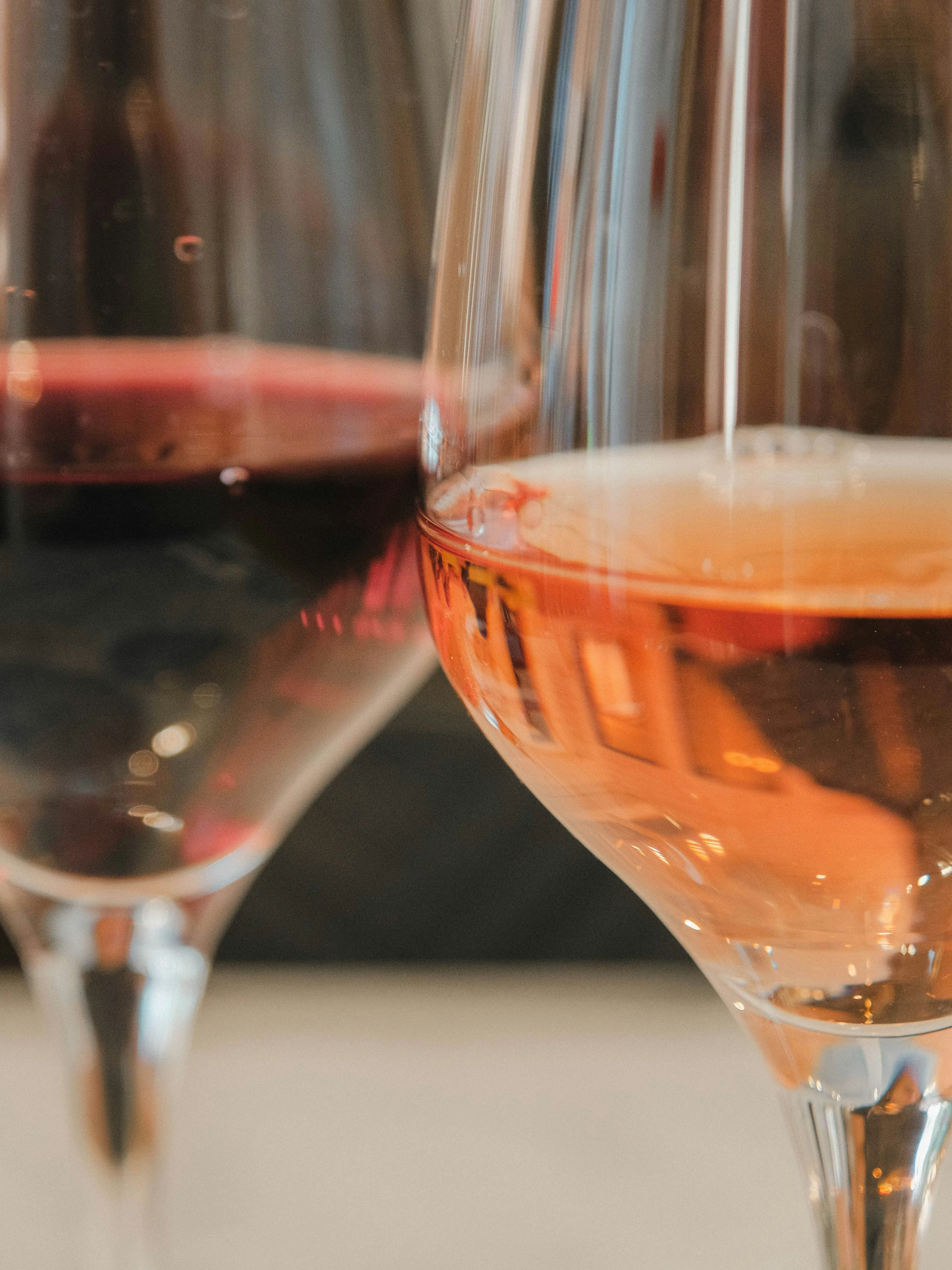 Two glasses of wine, one red and one rosé.