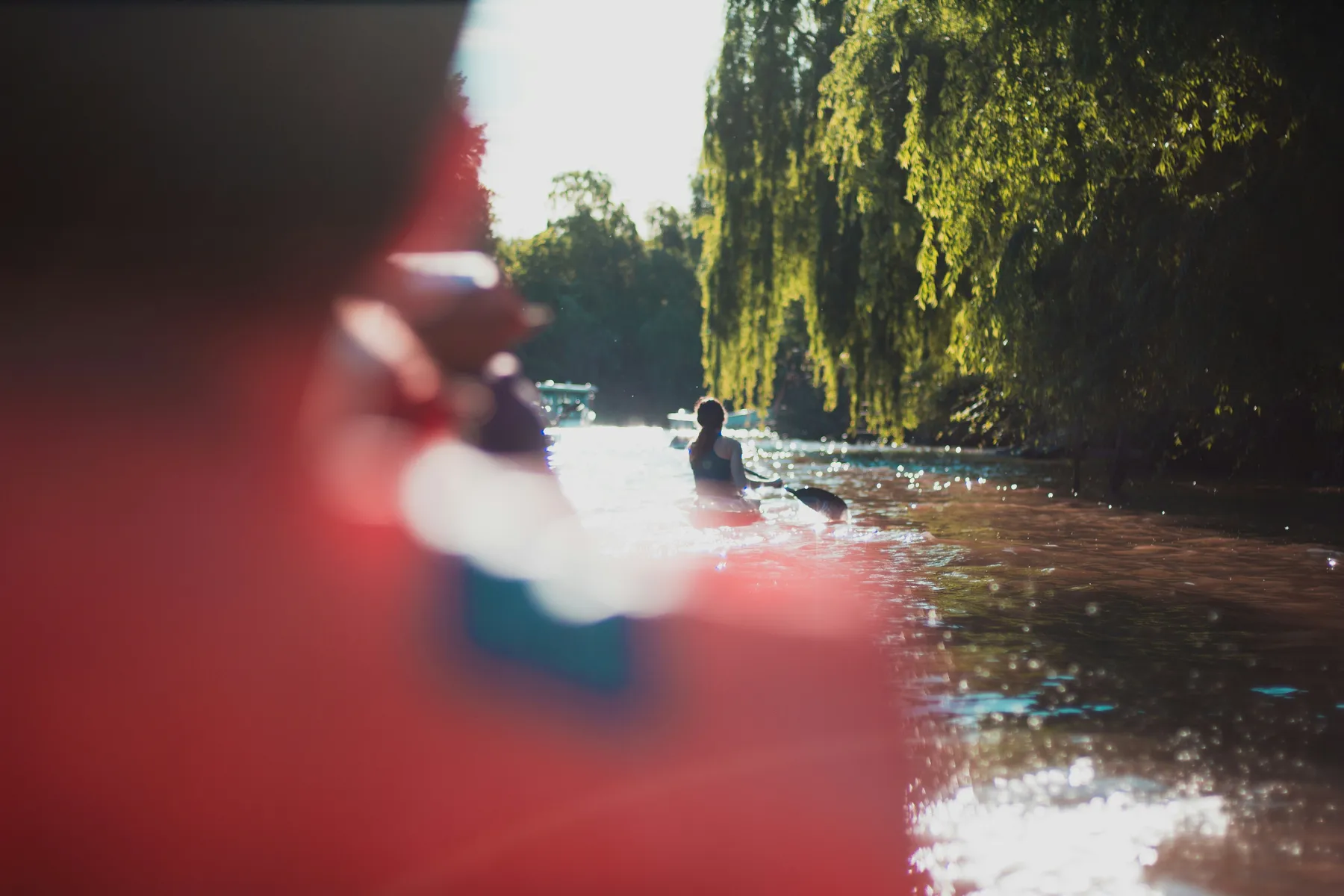 A kayaker paddling through the sunlit waterways of Tigre