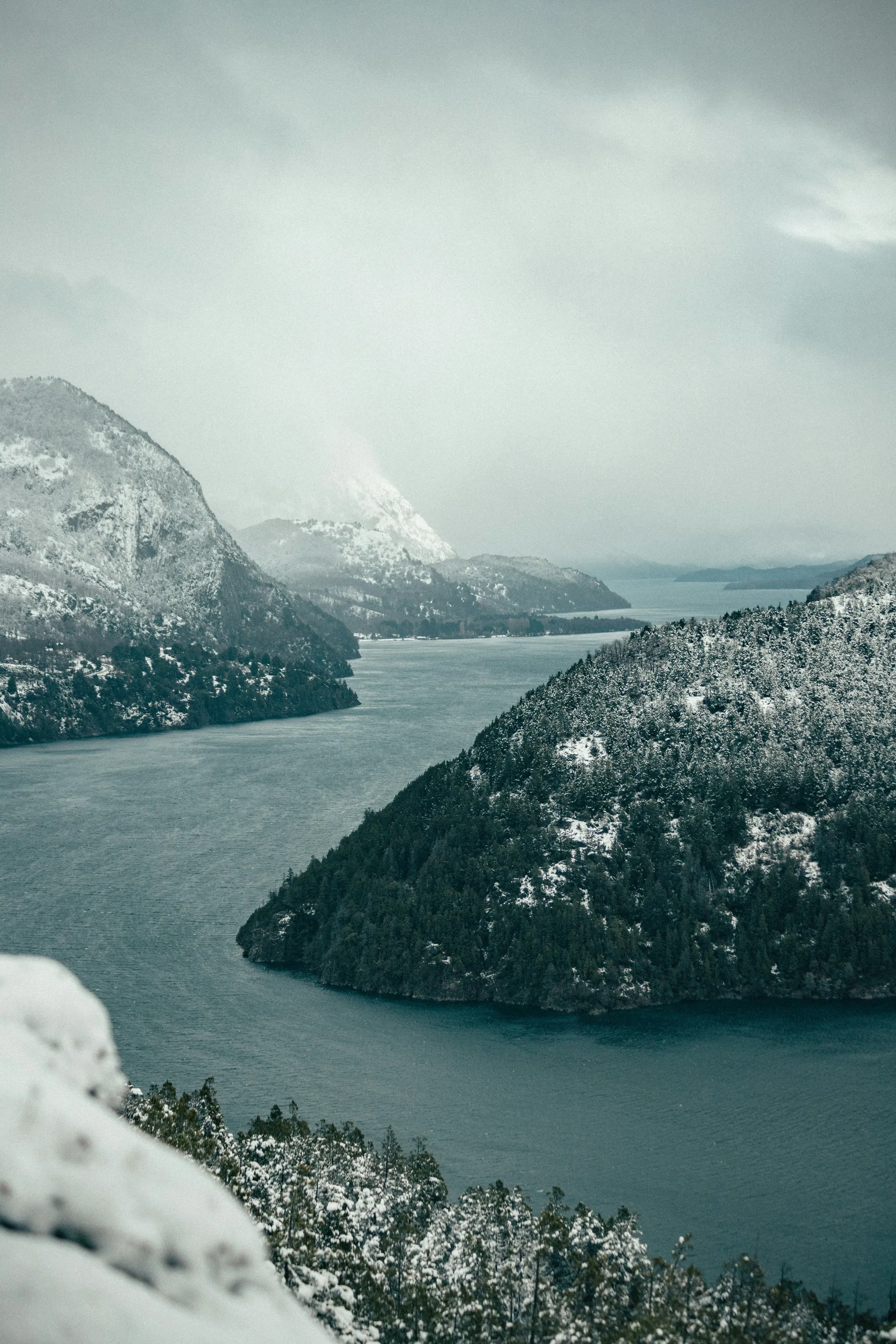 Snow-covered mountains across the water of Lago Lácar.