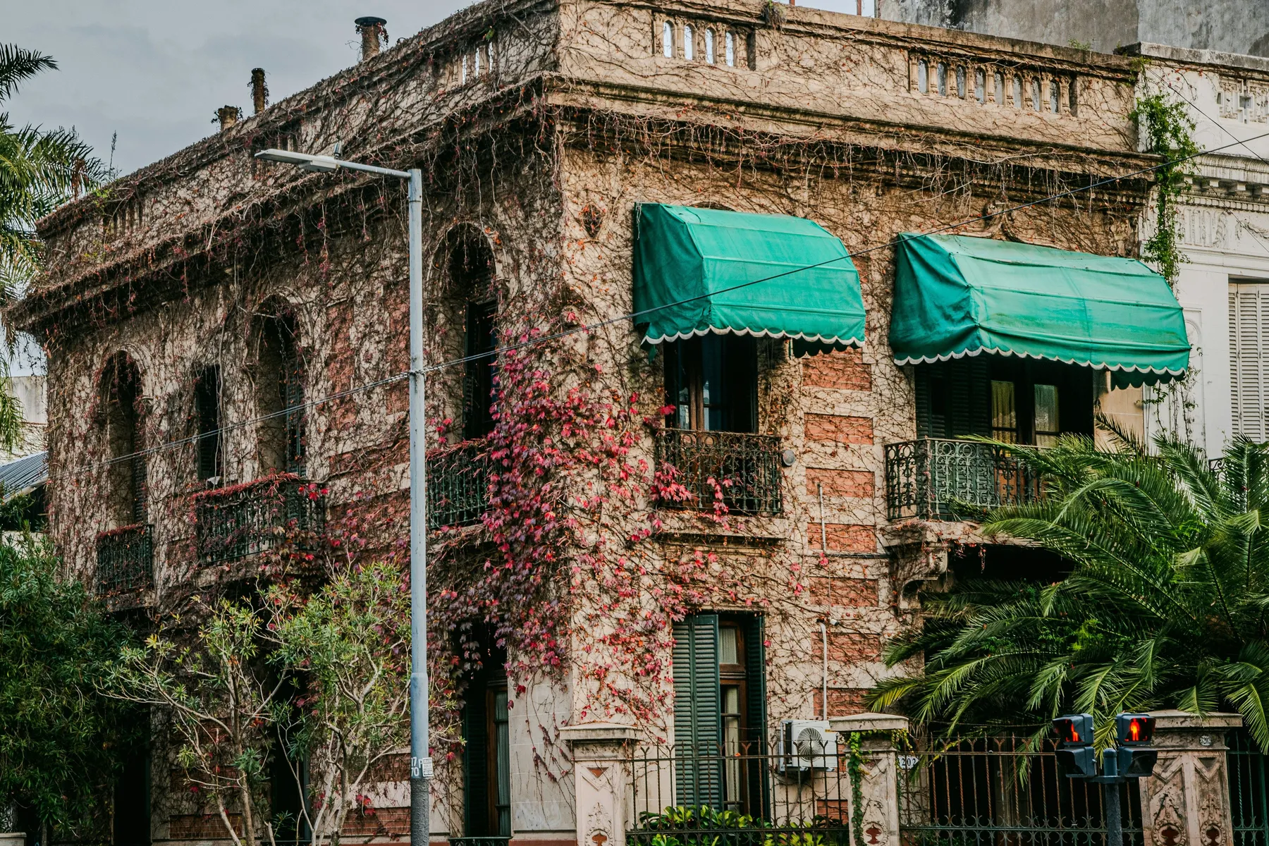 An old brick façade and green awning in Belgrano