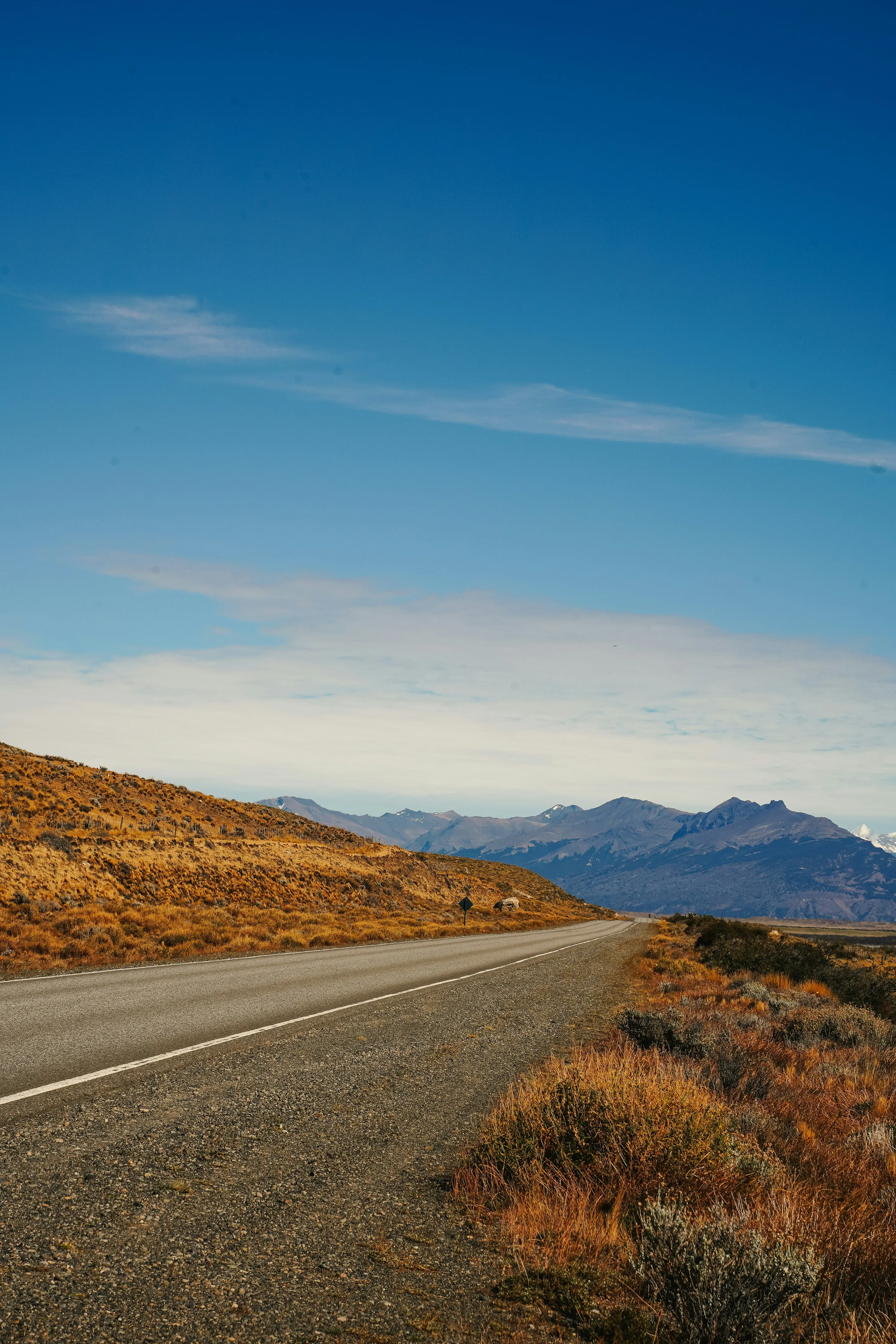 An open road crossing the broad Patagonian landscape near El Calafate